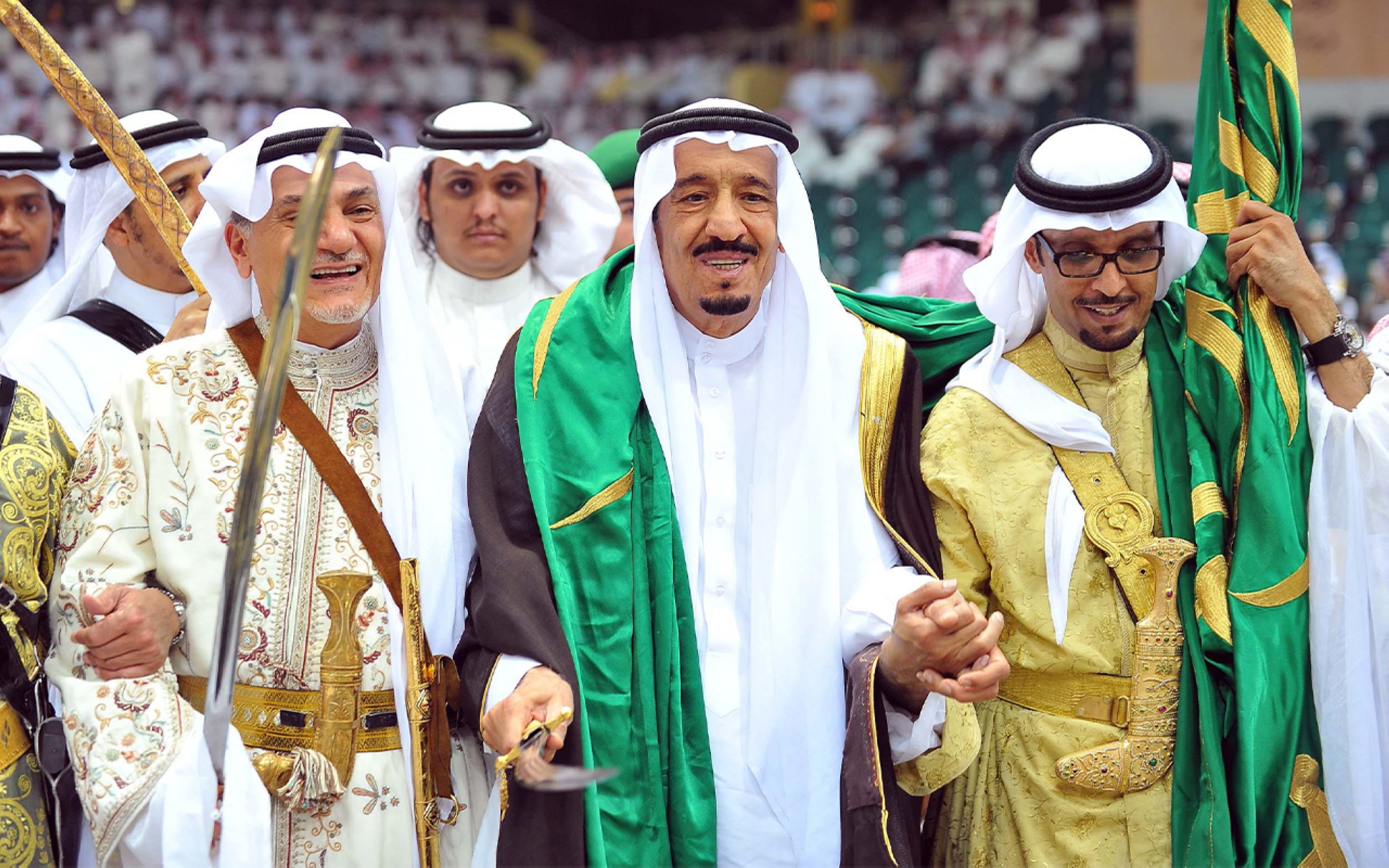 King Salman participating in the Saudi Ardah during an event. (SPA)