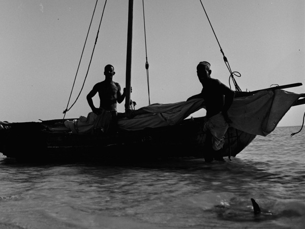 An old photo documenting a shipmaster and his companion preparing their shipment to sail into the sea (Darah).