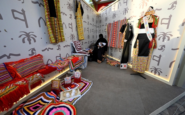 One of the craftswomen selling textiles on Founding Day. (SPA)