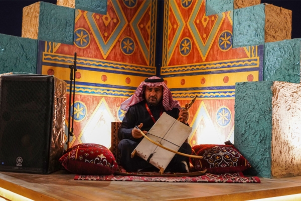 An artist playing the rebab, a traditional musical instrument. (Saudipedia)