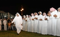 Al-Daha dance following the traditional style of rows while the poet maneuvers between them (SPA).