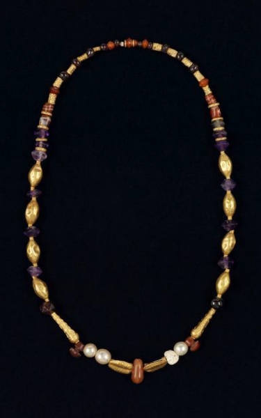 A necklace made of gold and adorned with gemstones and pearls, found in Ain Jawan. (Saudi Commission for Tourism and Antiquities)