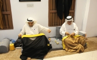 Two artisans showcasing the weaving of the cloak at al-Hasawi Bisht exhibition. (SPA)