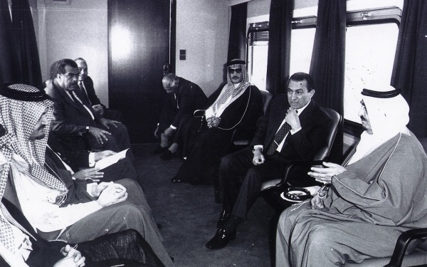 King Fahd during a visit to Egypt alongside Egyptian President Hosni Mubarak inside a carriage, with Prince Saud Al Faisal and several officials in front of them in 1989. (King Abdulaziz Foundation for Research and Archives (Darah))