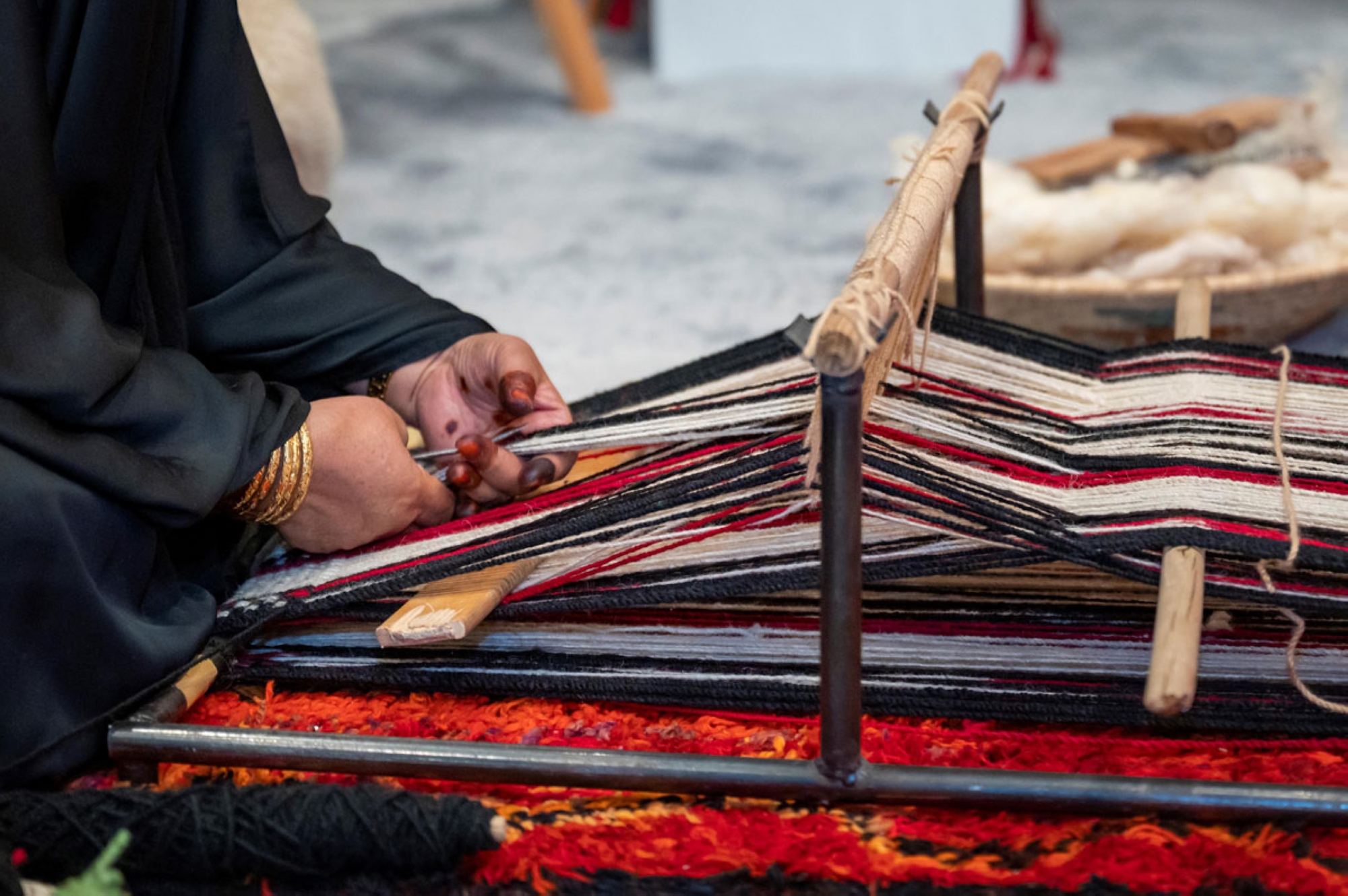 A woman engaged in al-Sadu weaving art. (SPA)