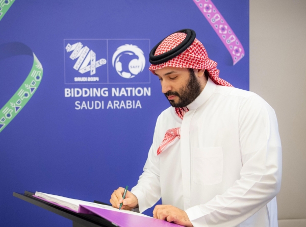 Crown Prince Mohammed Bin Salman signing the bid file for hosting the World Cup. (Saudi Football Federation Media Center)