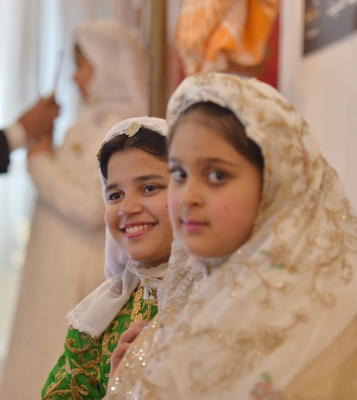 Two girls in the traditional attire of al-Madinah al-Munawwarah among the participants in al-Madinah booth at al-Janadriyah Festival. SPA. (Darah)