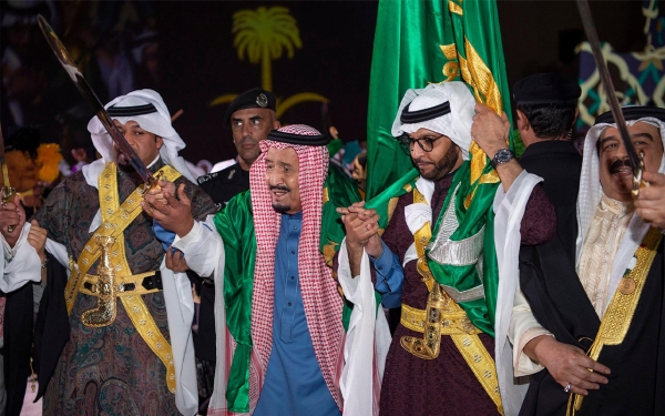 King Salman performing the Saudi Ardah at the opening ceremony of the development project for the historic al-Turaif neighborhood. (SPA)