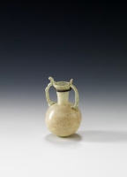 A bottle made of semi-transparent glass with two handles, used for storing perfumes. (Saudi Commission for Tourism and Antiquities)