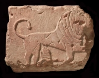 A rectangular block of stone featuring a carving of a lioness breastfeeding her cub. (Saudi Commission for Tourism and Antiquities)