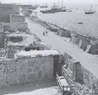Wooden boats and ships on the shore of al-Jubayl in the Eastern Province. Ilo Battigelli. 1950. (King Abdulaziz Foundation for Research and Archives (Darah))