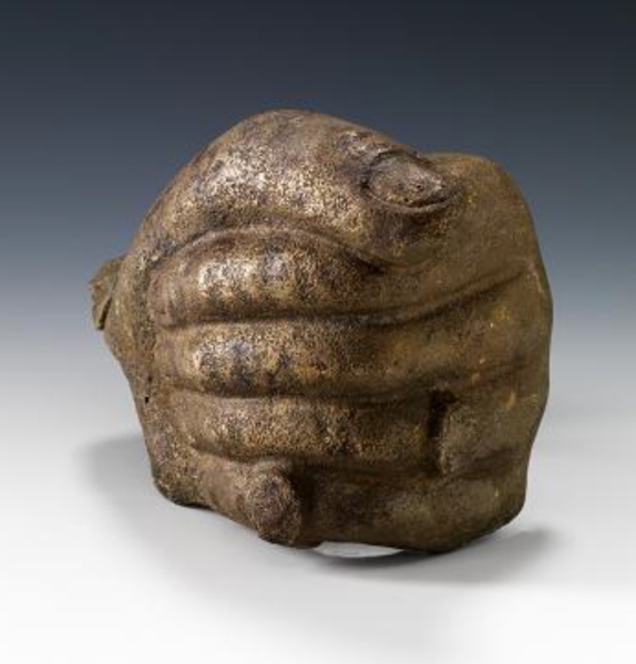 An ancient artifact made of bronze, shaped as a human fist. (Saudi Commission for Tourism and Antiquities)