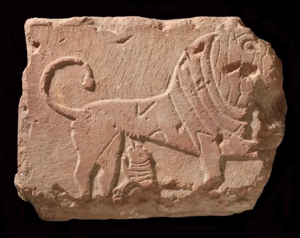 A rectangular block of stone featuring a carving of a lioness breastfeeding her cub. (Saudi Commission for Tourism and Antiquities)