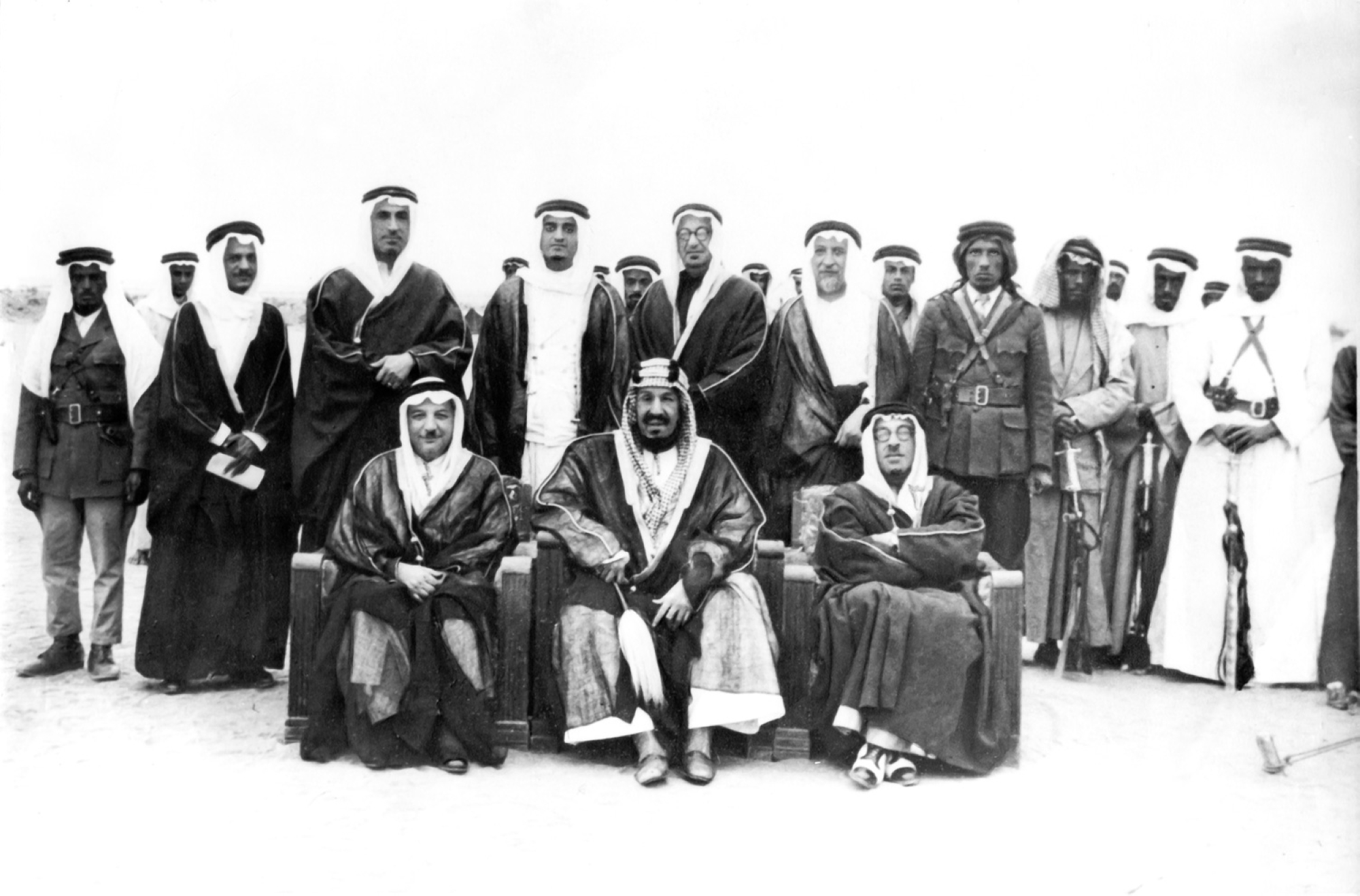 King Abdulaziz in Rawdat al-Tanhat, north of Riyadh, in 1943. Behind him stands his son, King Fahd, with Lebanese Prime Minister Riad al-Solh to his right and Lebanese Foreign Minister Selim Takla to his left. (King Abdulaziz Royal Reserve)
