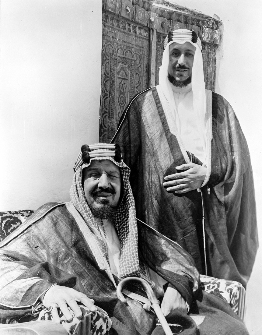 الملك سعود واقفًا بجوار والده الملك عبدالعزيز. (دارة الملك عبدالعزيز)