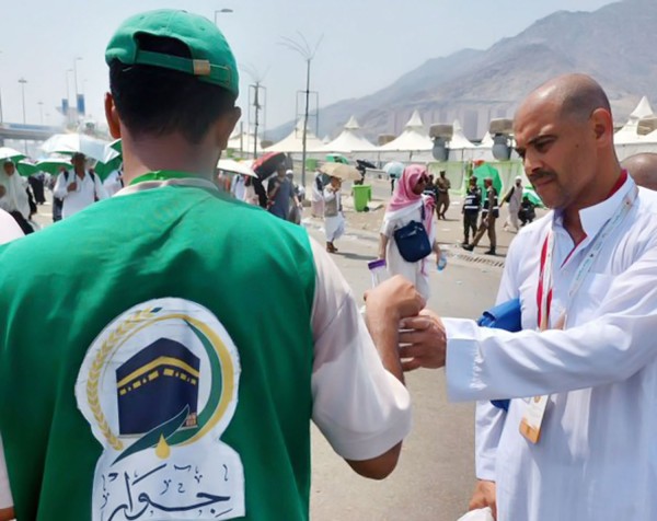 أحد منسوبي جمعية جوار يوزع الماء على حجاج بيت الله الحرام في مشعر منى. (المركز الإعلامي لجمعية البر لقرى جنوب مكة المكرمة)