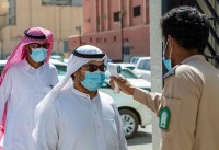 فحص درجة الحرارة والالتزام بارتداء الكمامة قبل الدخول للمنشآت والأسواق خلال جائحة كورونا. (دارة الملك عبدالعزيز)